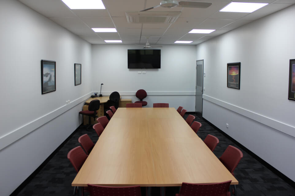Community Recreation and Sports Hub meeting room with a long table and chairs