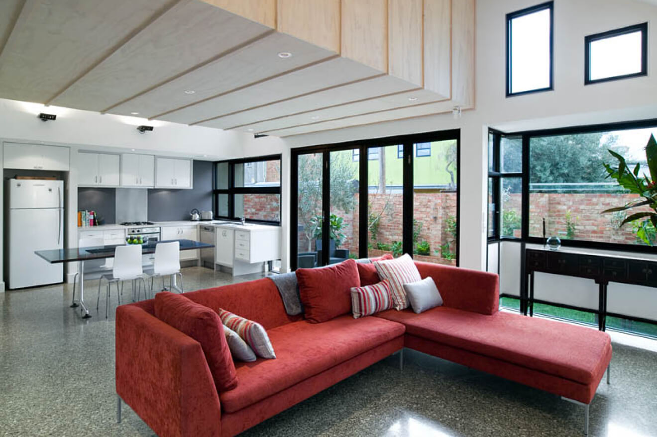 Westgarth Street Residence’s L-shaped red couch in the living room