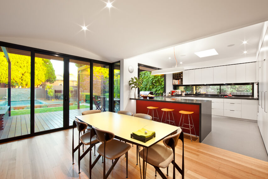 Orrong Road Residence’s dining area with a view of the kitchen